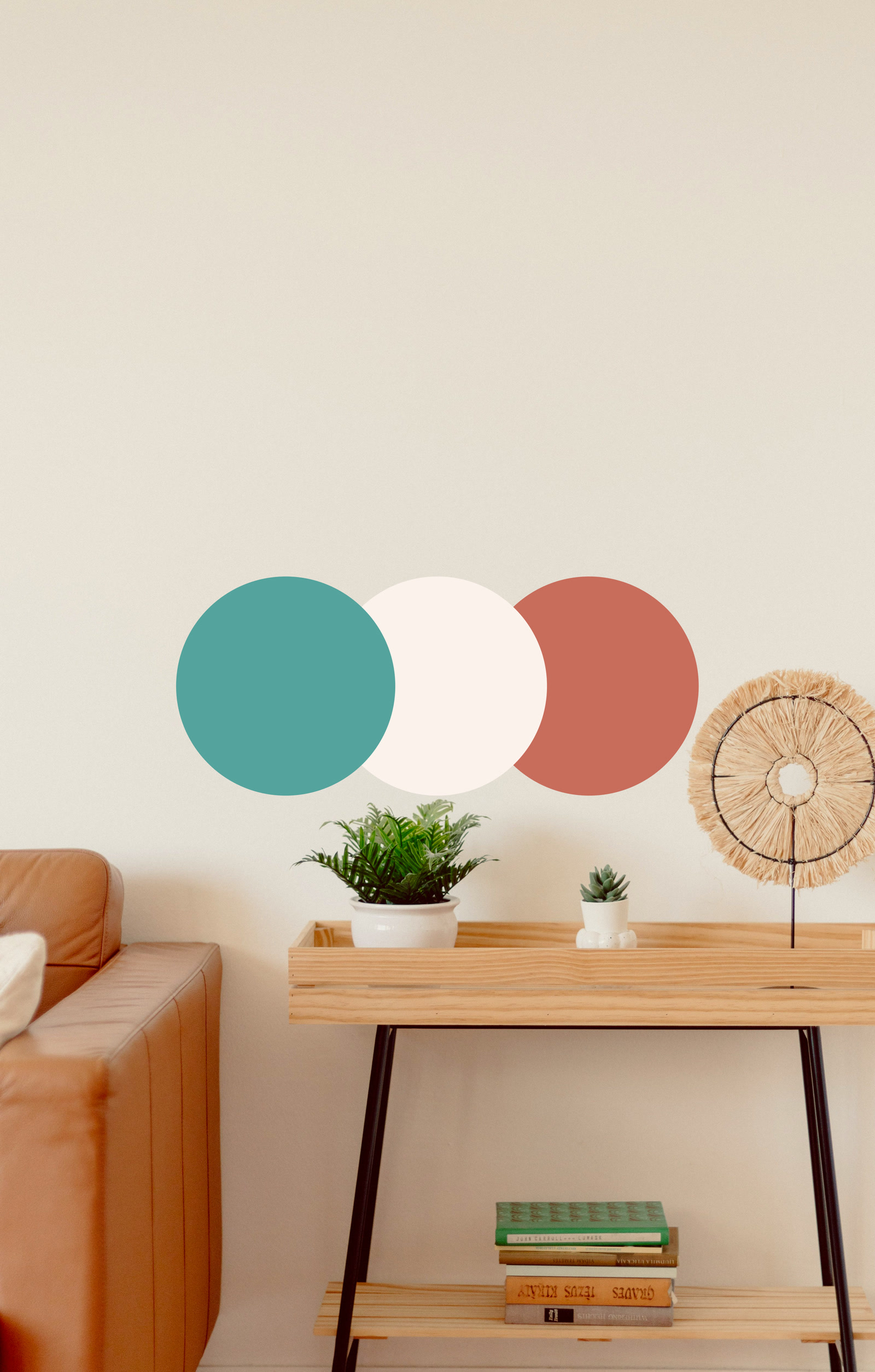 The WellPsyche palette as three overlapping circles &mdash; teal, cream and clay &mdash; on a warm neutral wall above a console table